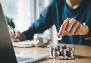 Man hands putting coins stack, Concept business finance saving money, funding and investment.